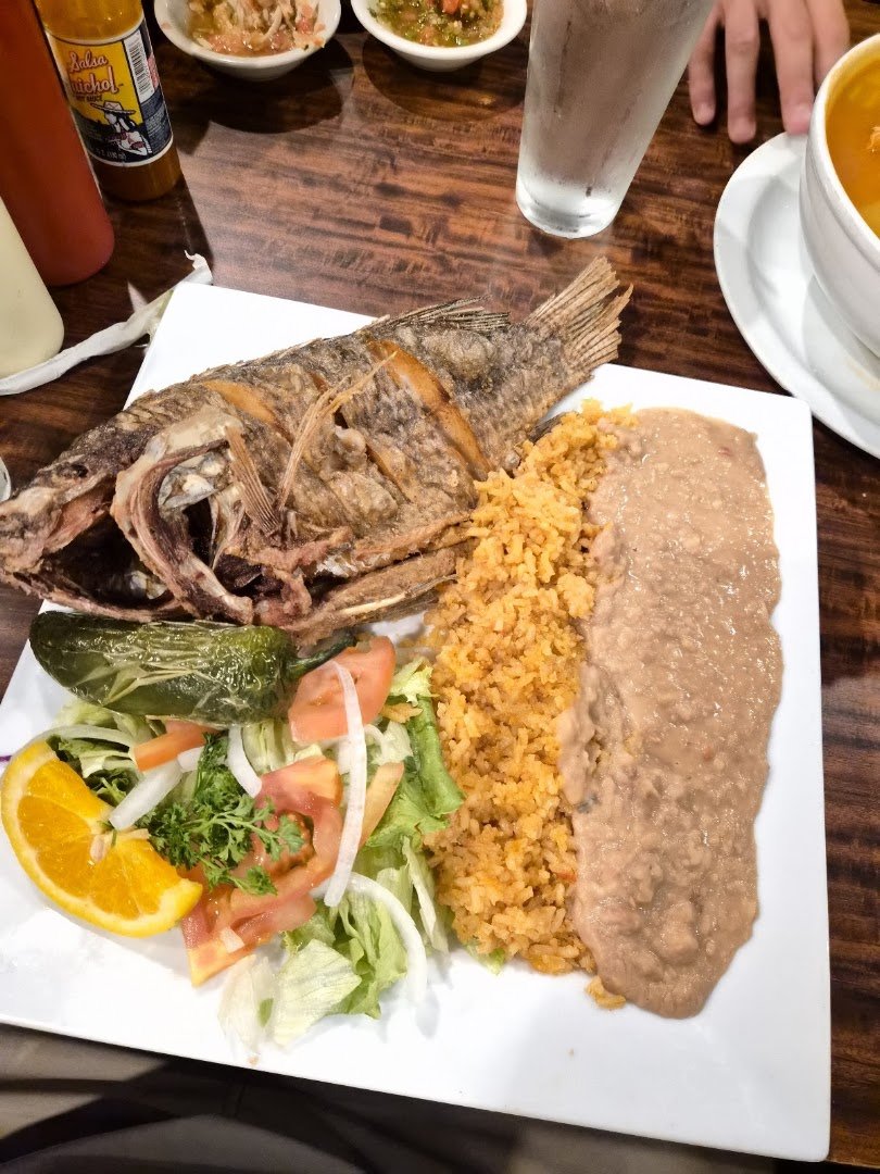 Colorful plates with shrimp cocktail and enchiladas.
